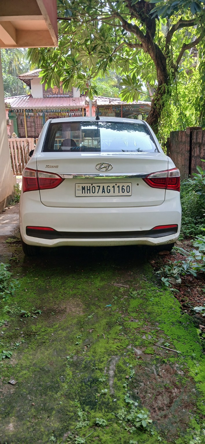 White Hyundai Xcent available for car rental in Malvan